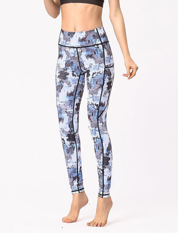 Woman wearing high-waist blue camouflage sports leggings, perfect for yoga and workouts, featuring a soft and breathable fabric.